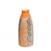 A tall cream ceramic vase with hand-painted orange speckled patterns and black wavy lines