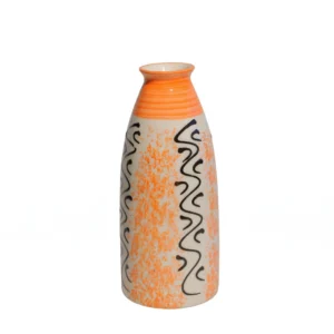 A tall cream ceramic vase with hand-painted orange speckled patterns and black wavy lines