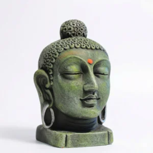 Front view of a weathered moss-green Buddha head bust with a small orange dot on the forehead