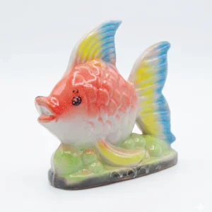 A vibrant hand-painted ceramic fish figurine with orange, yellow, and blue fins on a green bubble base