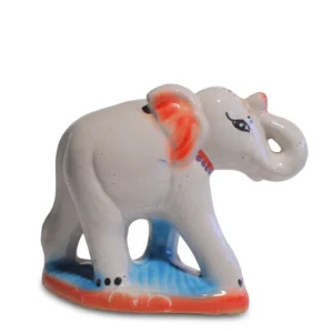 Hand-painted white ceramic elephant with red ears and a blue base, trunk raised for good luck