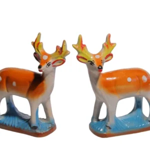 A pair of hand-painted ceramic deer statues with orange spotted bodies and yellow antlers on a blue base