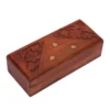 Closed view of a long rectangular wooden box with triangular floral carvings