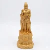 Frontal view of a golden-colored Thiruvalluvar statue seated in meditation with a palm-leaf manuscript.