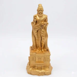 Frontal view of a golden-colored Thiruvalluvar statue seated in meditation with a palm-leaf manuscript.