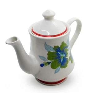 A white ceramic teapot-shaped storage jar with blue and green floral patterns and a crimson red base, shown with its matching lid placed beside it on a white background.
