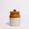 A 250ml dual-tone ceramic jar with its lid placed leaning against the base, showing the glossy brown top and cream-white stoneware body.