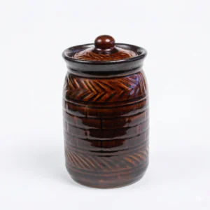 A handcrafted 300ml ceramic jar with a glossy brown top and a cream-white base featuring an embossed brick texture, isolated on a white background.