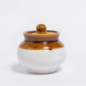 A handcrafted 500ml ceramic barnie jar with a glossy brown upper half and cream base, standing on a white background with its matching lid.
