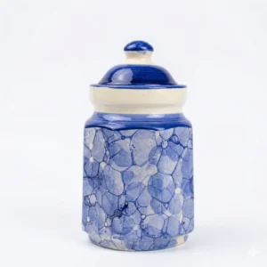 A traditional ceramic barnie pickle jar featuring a unique blue and white bubble-patterned glaze and a solid cobalt blue lid, isolated on a white background.
