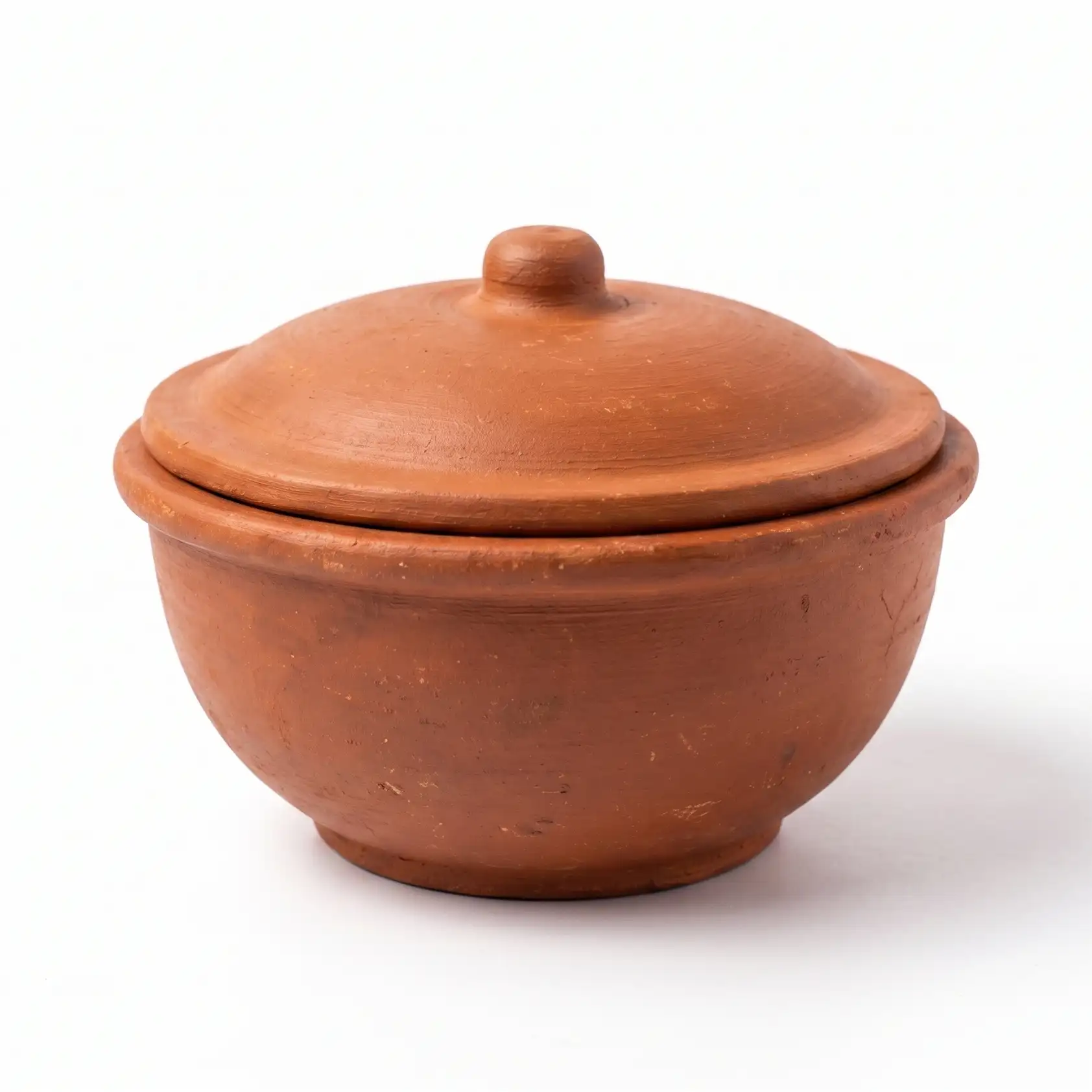 Handcrafted natural clay cooking pot with lid for traditional recipes.