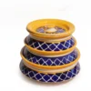 Front view of Givieo white ceramic jar with hand-painted indigo blue leaf patterns and matching lid.