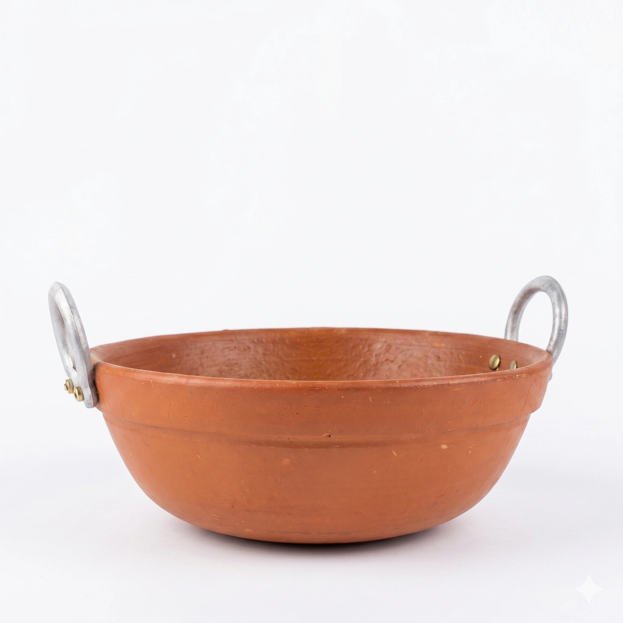 Authentic red terracotta kadai chatti filled with steaming fish curry and green chilies.