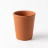 Two Vins Art House terracotta water cups arranged together showing their natural earthy texture.