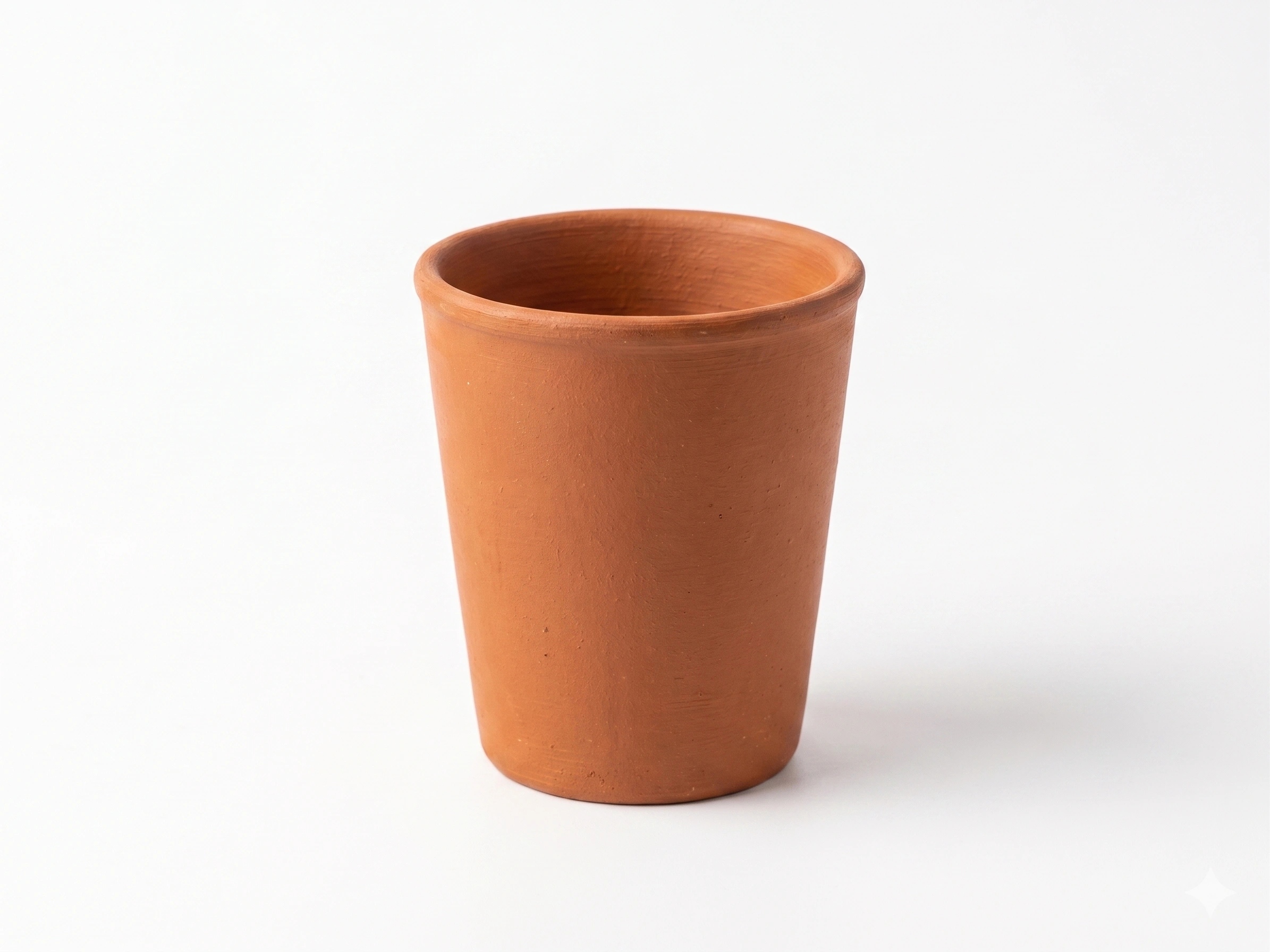 Two Vins Art House terracotta water cups arranged together showing their natural earthy texture.